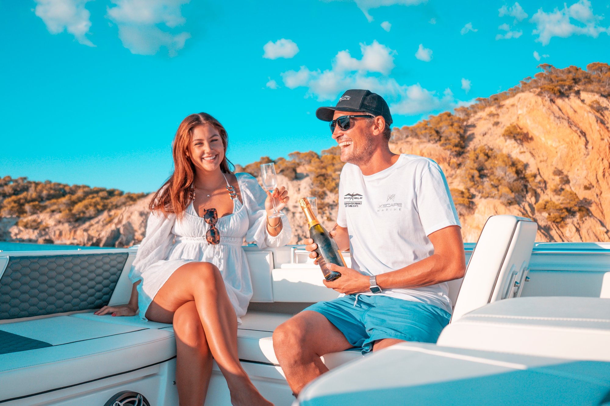 A couple relaxes on the plus seating on board the Invincible 37 Catamaran in Palma Mallorca - the best boat to buy!